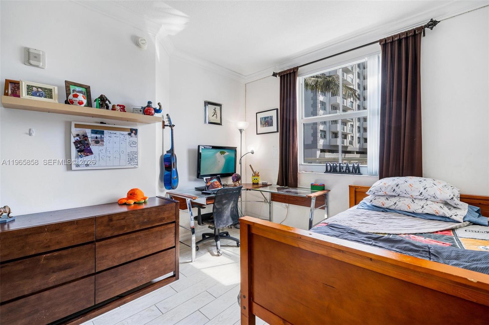 9172 Collins Avenue, Unit 210 Surfside, FL 33154 - Photo 20 of 41 a bedroom with furniture and a window