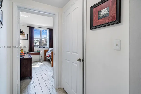 a view of a hallway with a livingroom and a workspace
