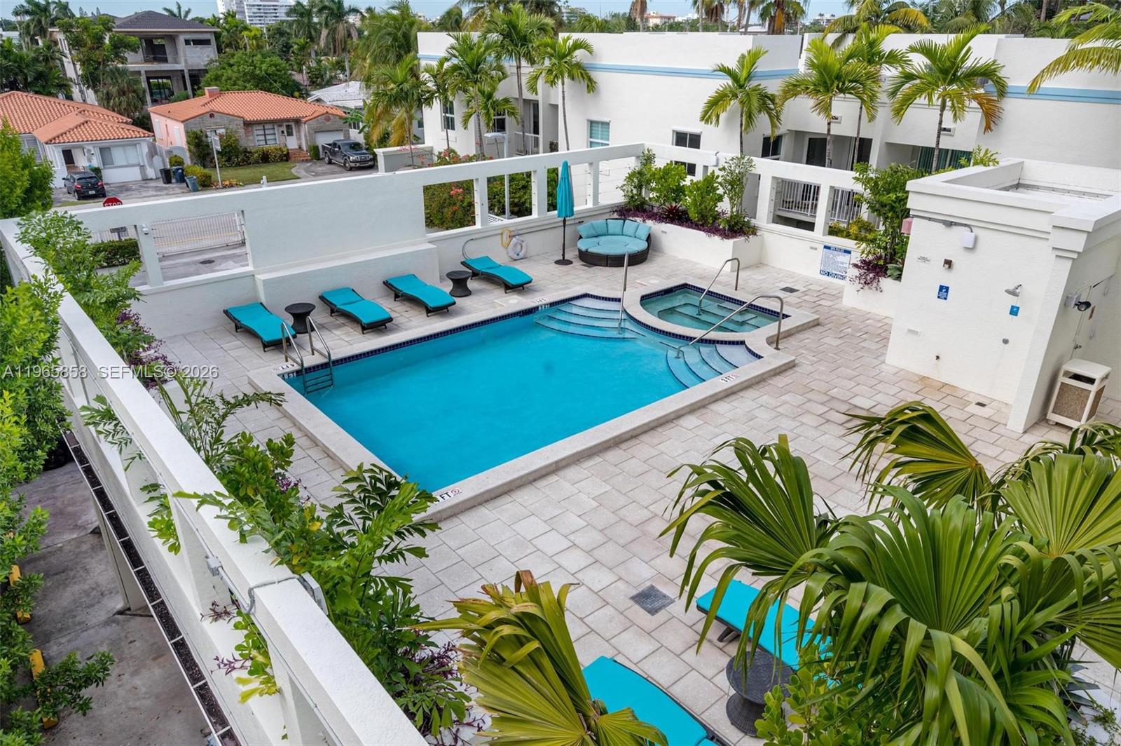 9172 Collins Avenue, Unit 210 Surfside, FL 33154 - Photo 25 of 41 an aerial view of a house with a garden and swimming pool