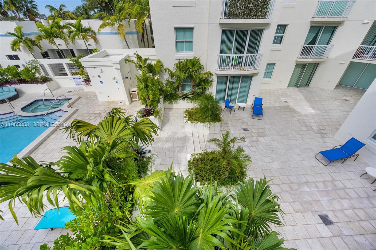 9172 Collins Avenue, Unit 210 Surfside, FL 33154 - Photo 26 of 41 a potted plant sitting in front of a house
