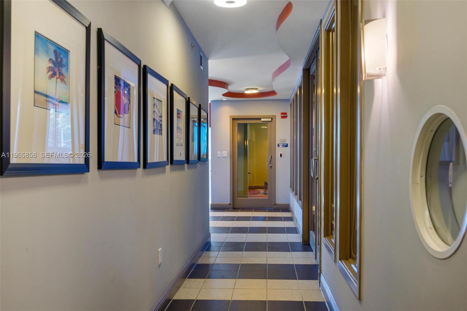 9172 Collins Avenue, Unit 210 Surfside, FL 33154 - Photo 36 of 41 a view of a hallway with painted walls and windows