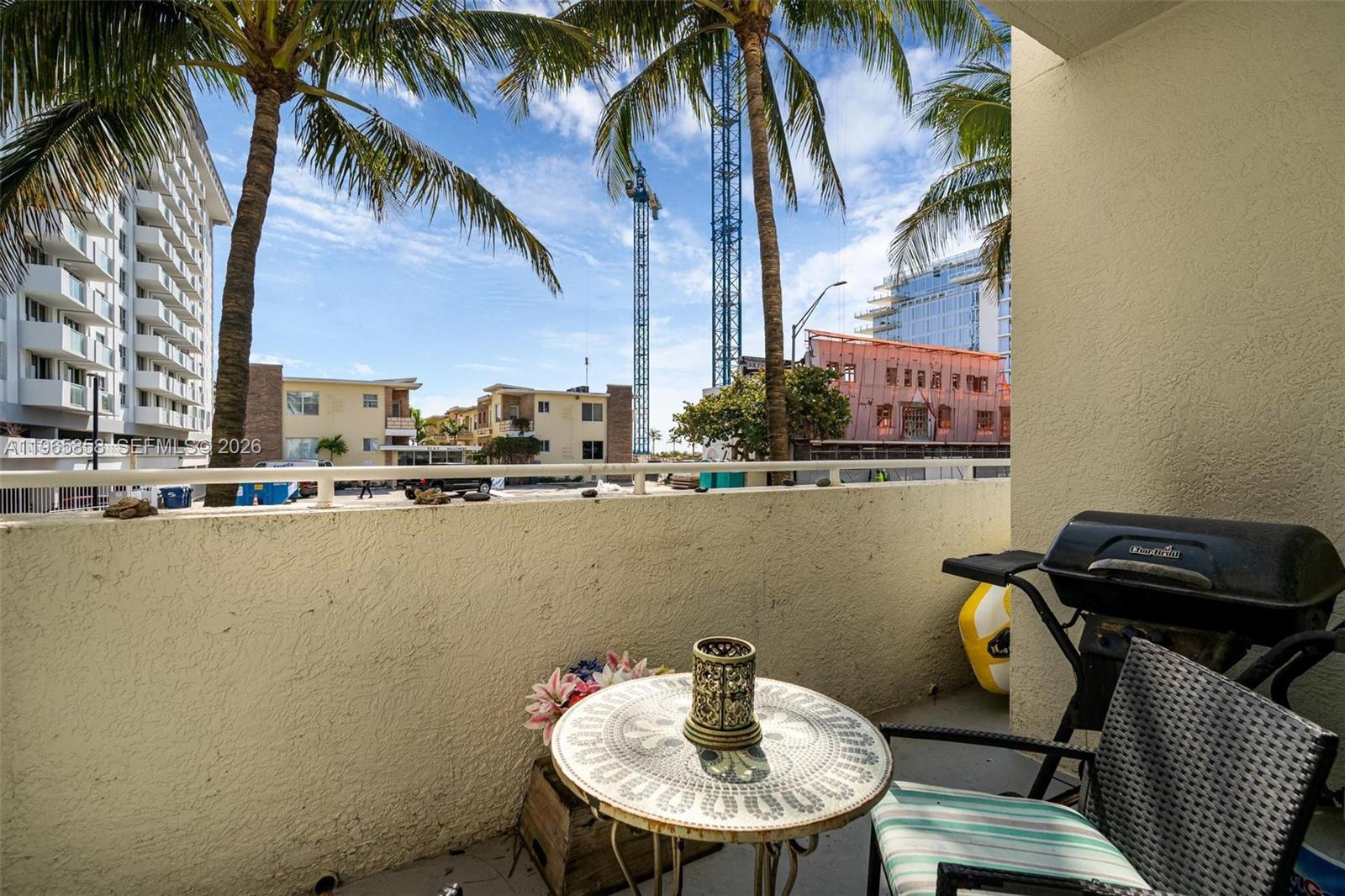 9172 Collins Avenue, Unit 210 Surfside, FL 33154 - Photo 6 of 41 a view of a swimming pool with a table and chairs