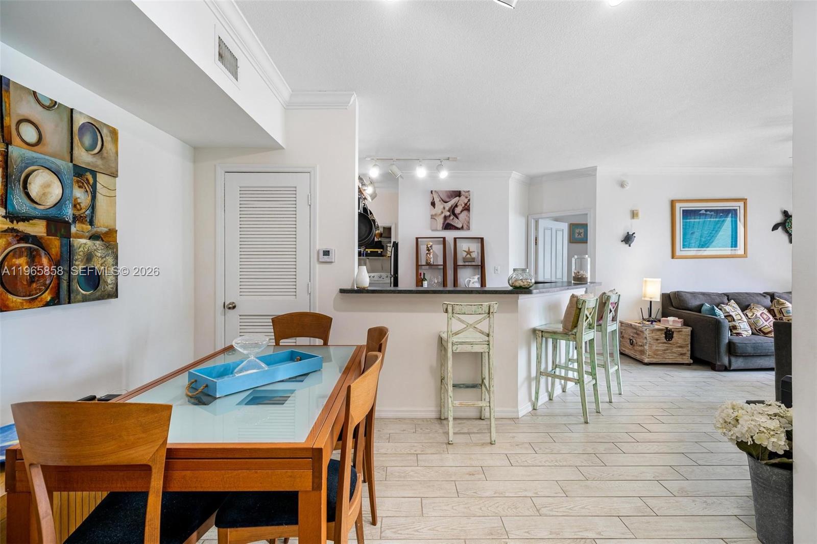9172 Collins Avenue, Unit 210 Surfside, FL 33154 - Photo 9 of 41 a view of a dining room with furniture