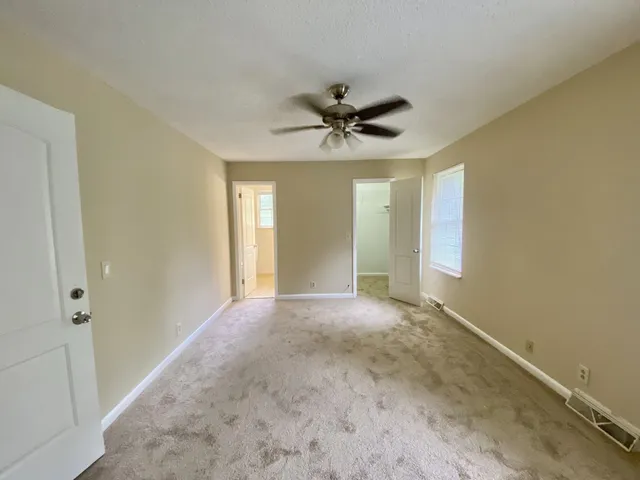 a view of a livingroom with a ceiling fan and window