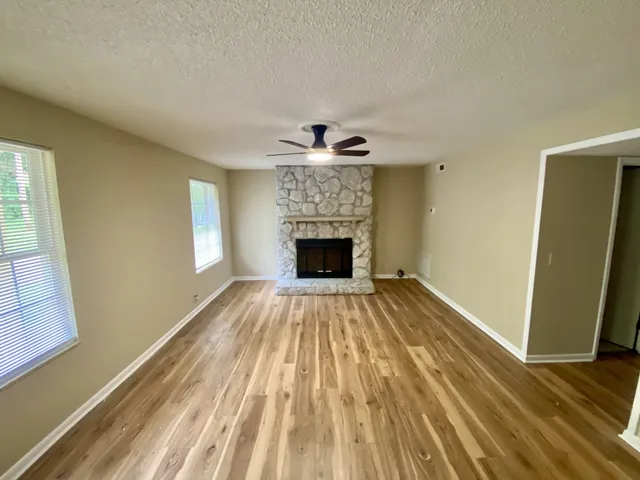wooden floor in an empty room with a fireplace