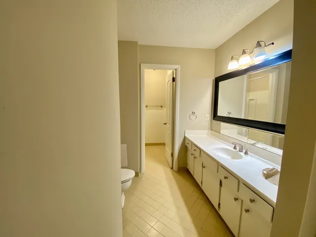 a spacious bathroom with a double vanity sink and a mirror