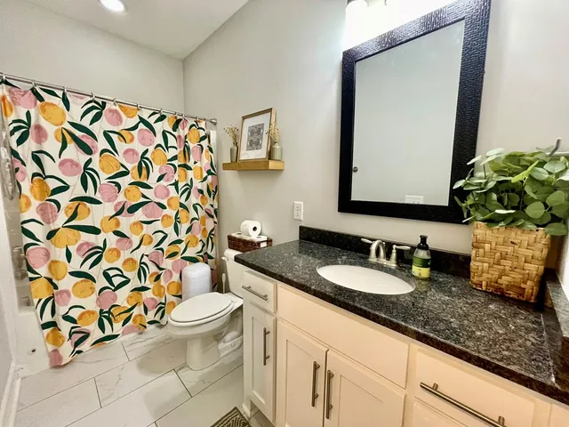 a view of a kitchen with wooden floor and a refrigerator