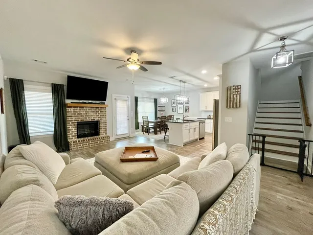 a spacious bedroom with a bed and ceiling fan