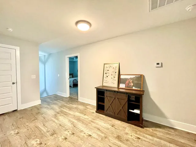 a bedroom with a bed and a television