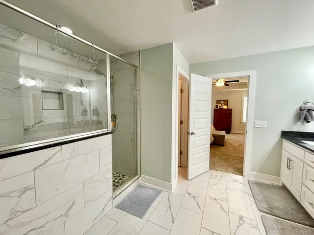 a bathroom with a granite countertop sink and a mirror