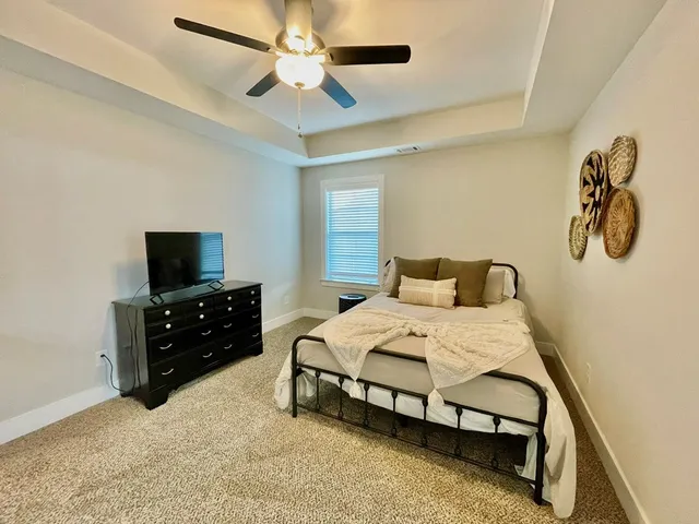 a bedroom with a bed and a chair