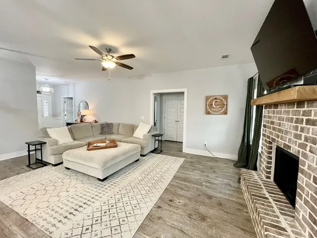 a living room with furniture and wooden floor