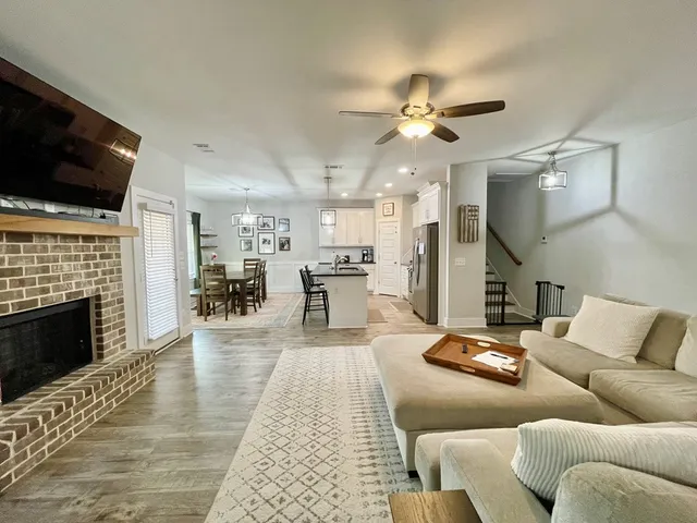 a kitchen with stainless steel appliances granite countertop a sink a stove and a refrigerator
