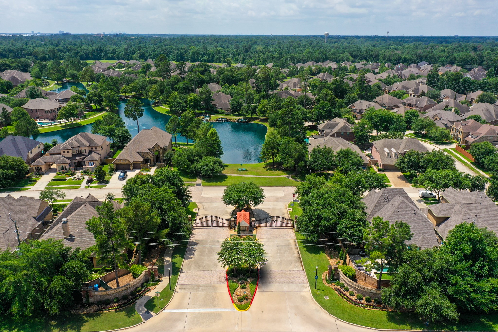 2407 Hendricks Lakes Drive Spring, TX 77388 - Photo 47 of 50 From above, Lakes of Cypress Forest shows off its gated entrance, lake-centered layout, and wooded surroundings, giving buyers a better feel for the setting before they ever reach the home. Winding streets, fountains, walking paths, and green space all reinforce the neighborhood’s scenic, connected lifestyle just minutes from Spring conveniences.
