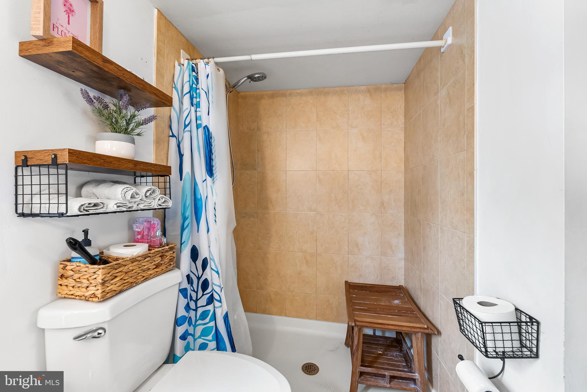 1812 Lancaster Street Baltimore, MD 21231 - Photo 18 of 38 a bathroom with a toilet a sink and a shower curtain