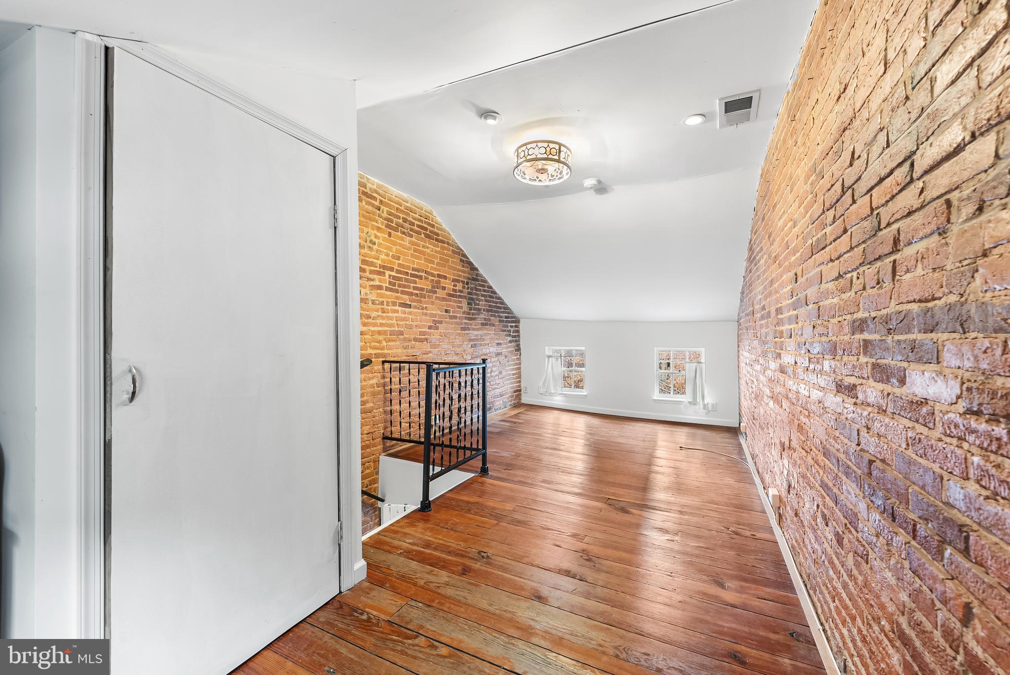 1812 Lancaster Street Baltimore, MD 21231 - Photo 21 of 38 a view of a hallway with wooden floor and staircase