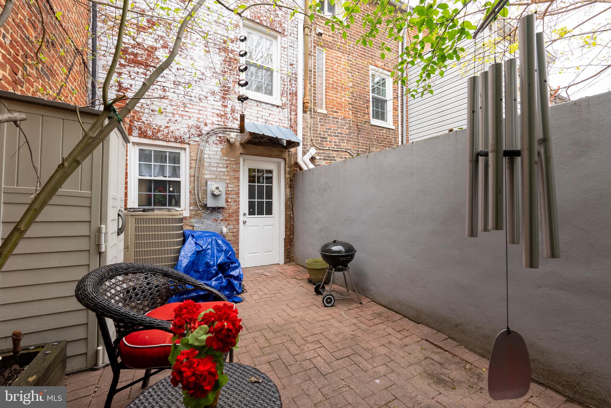 1812 Lancaster Street Baltimore, MD 21231 - Photo 29 of 38 a backyard of a house with table and chairs