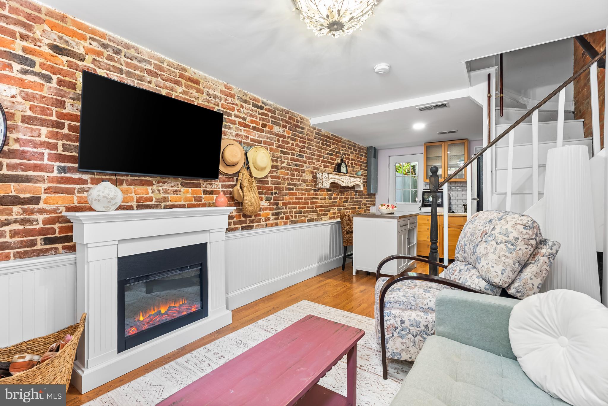 1812 Lancaster Street Baltimore, MD 21231 - Photo 3 of 38 a living room with furniture a flat screen tv and a fireplace