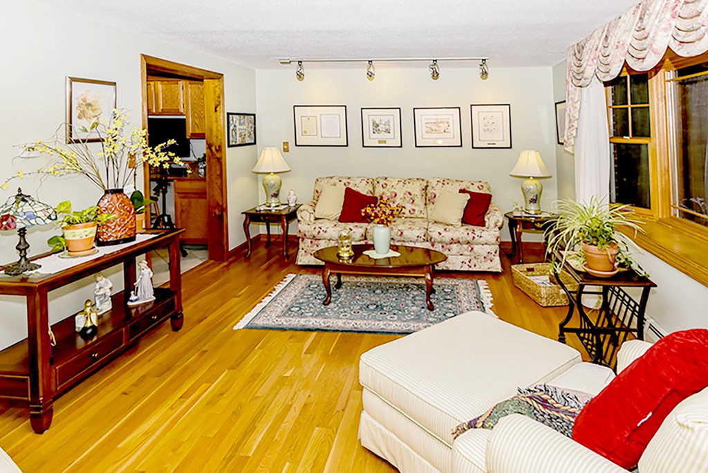 86 Leland Road Boston, MA 02467 - Photo 3 of 18 a living room with furniture and wooden floor