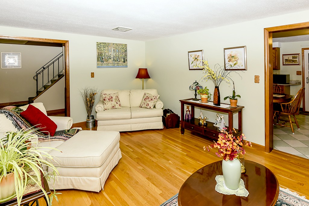 86 Leland Road Boston, MA 02467 - Photo 4 of 18 a living room with furniture flowers and a table