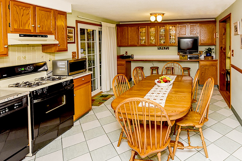 86 Leland Road Boston, MA 02467 - Photo 5 of 18 a kitchen with stainless steel appliances a stove a sink and a microwave