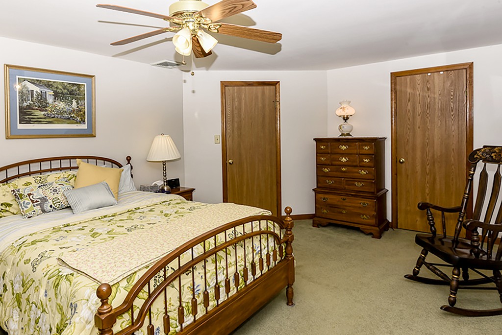 86 Leland Road Boston, MA 02467 - Photo 10 of 18 a bedroom with a bed and a chandelier