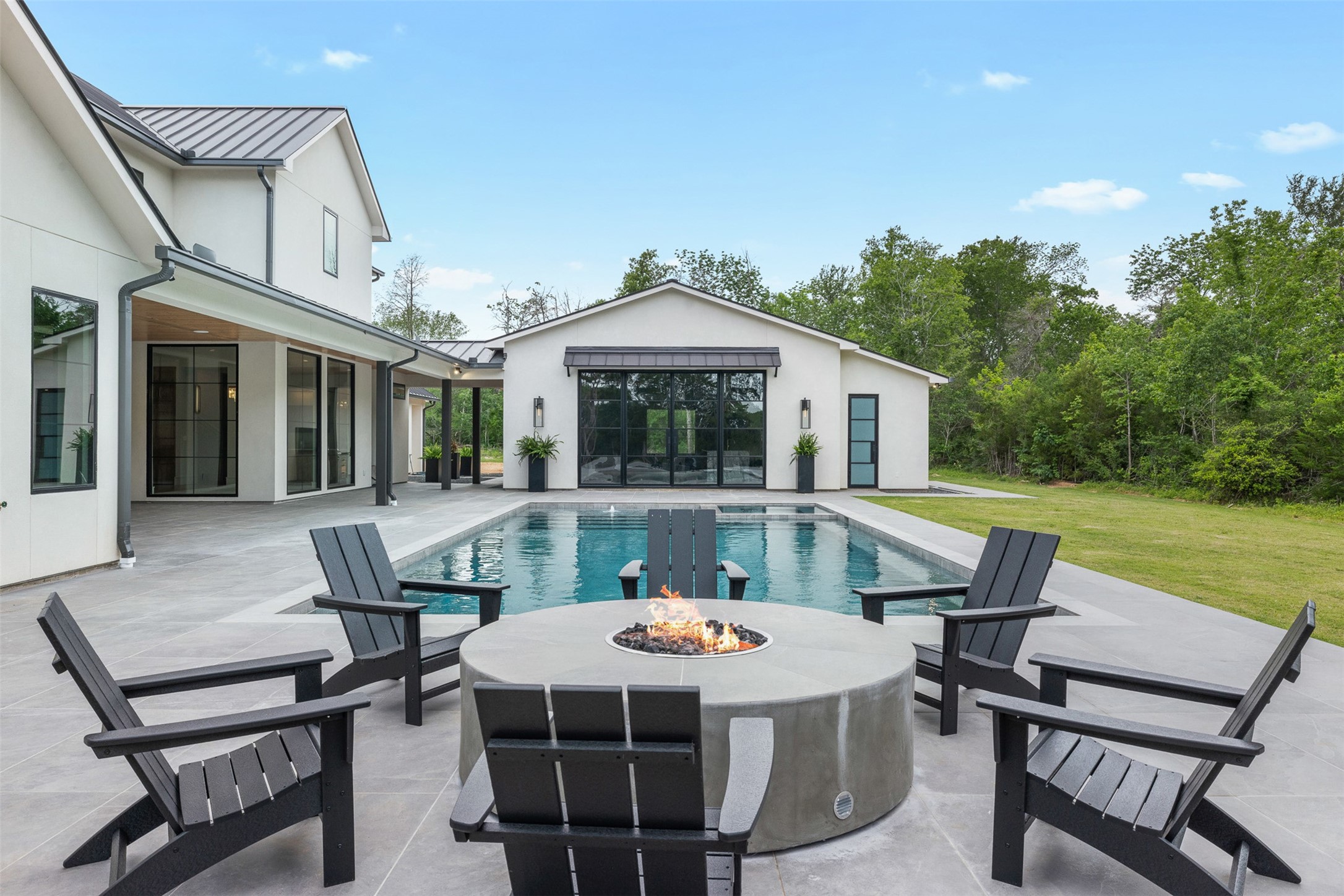 770 South Weyand Road Round Top, TX 78954 - Photo 5 of 50 a view of a patio with table and chairs with wooden floor and fence