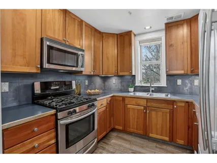 a kitchen with stainless steel appliances granite countertop a stove a sink dishwasher and a microwave