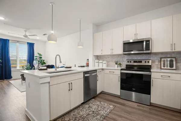 a kitchen with a sink stove and microwave