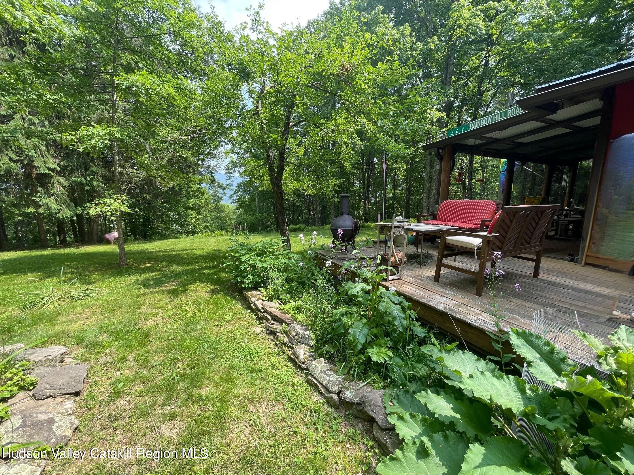 367 Rainbow Hill Road Andes, NY 13731 - Photo 25 of 30 a backyard of a house with yard and outdoor seating