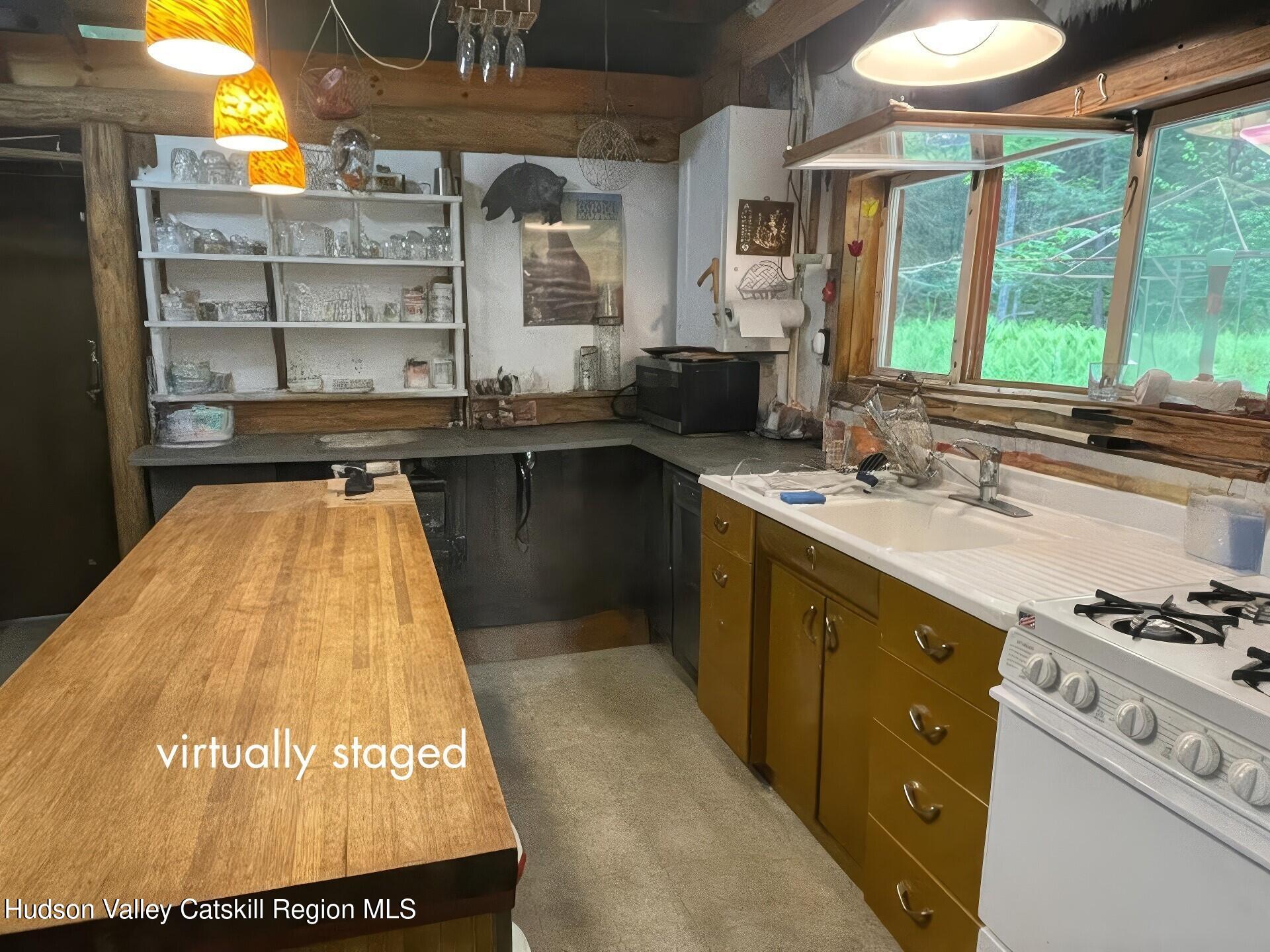 367 Rainbow Hill Road Andes, NY 13731 - Photo 9 of 30 a kitchen with kitchen island granite countertop a stove and a sink
