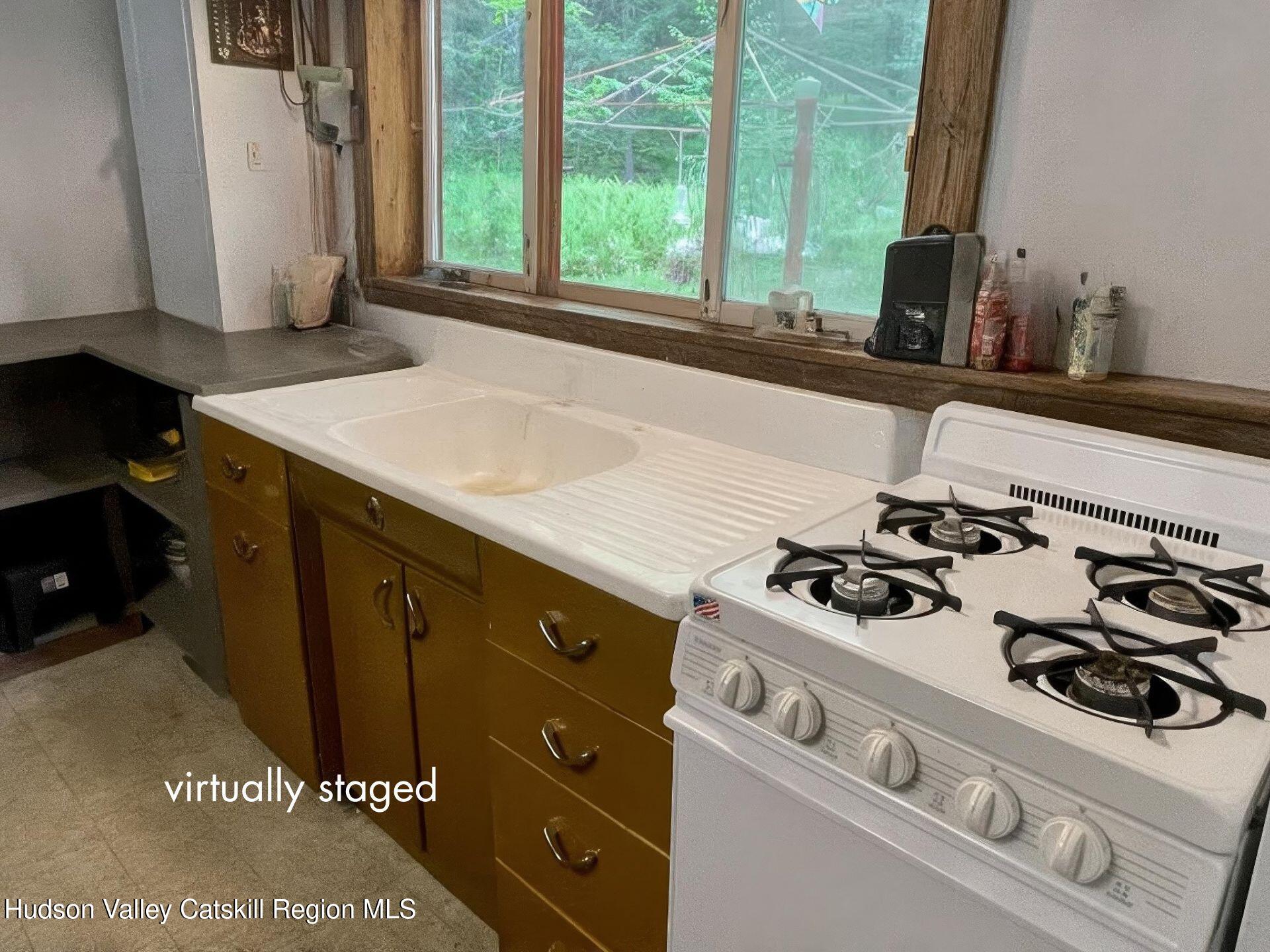 367 Rainbow Hill Road Andes, NY 13731 - Photo 10 of 30 a kitchen with a stove a sink and a window
