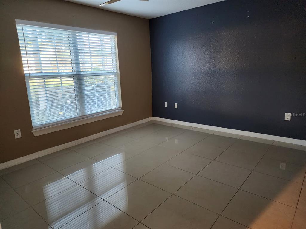 5483 Vineland Road, Unit 10107 Orlando, FL 32811 - Photo 11 of 17 an empty room with a empty space and a window