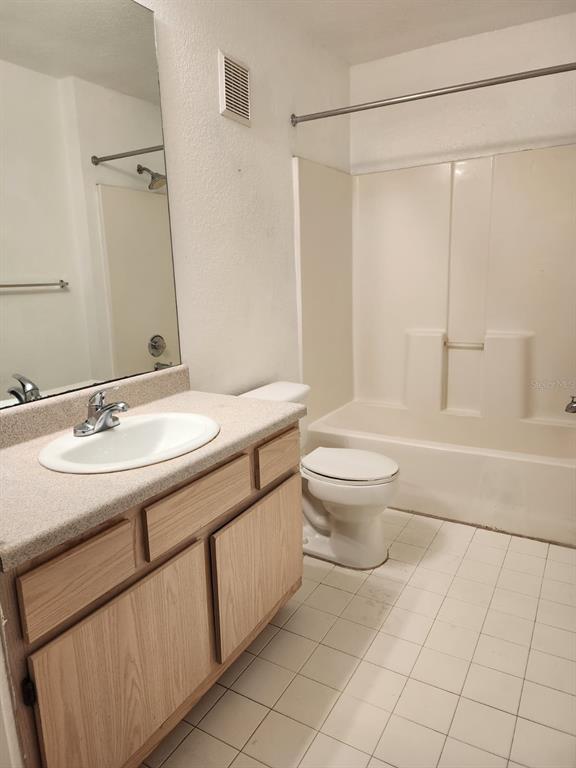 5483 Vineland Road, Unit 10107 Orlando, FL 32811 - Photo 15 of 17 a bathroom with a sink toilet and shower