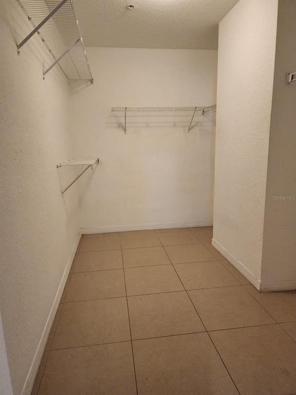 5483 Vineland Road, Unit 10107 Orlando, FL 32811 - Photo 16 of 17 a view of a room with racks on the wall