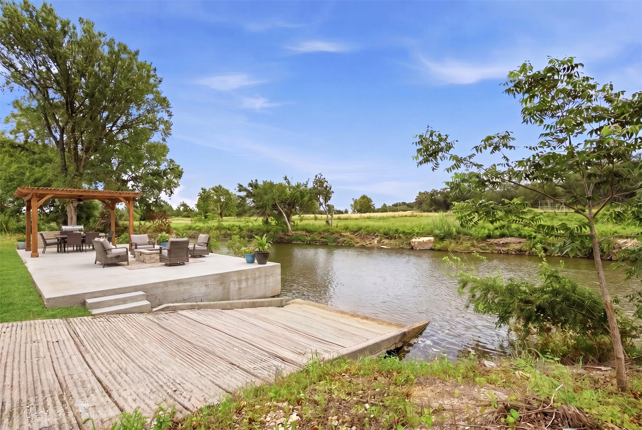 2043 Fm 971 Georgetown, TX 78626 - Photo 10 of 12 An AI generated virtual image of a ramp into the river and a spacious patio, perfect for outdoor entertaining. Permit/Approval required from Williamson County prior to any improvements.