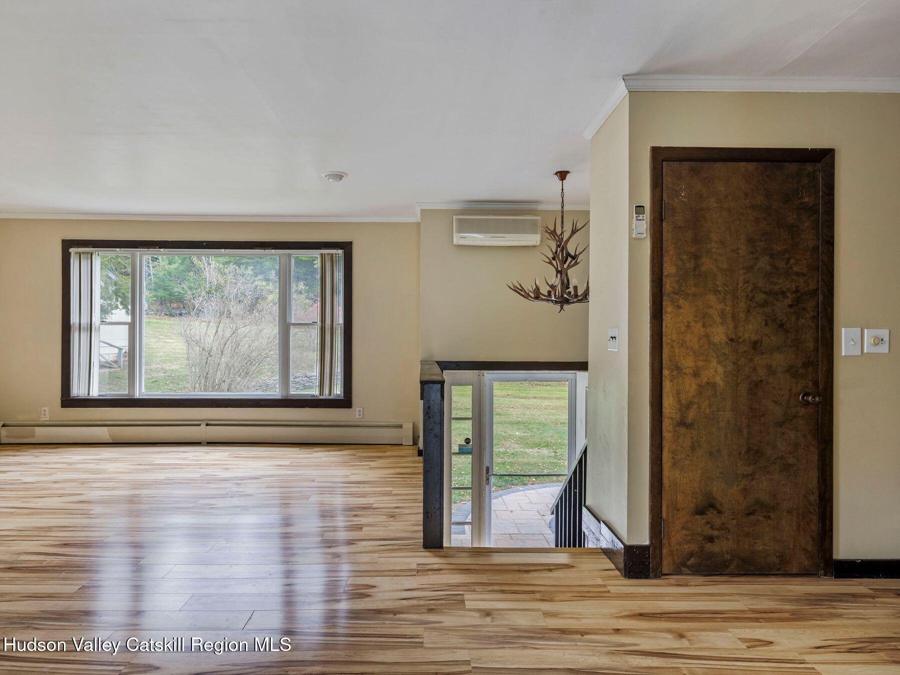 317 Mitchell Hollow Road Windham, NY 12496 - Photo 14 of 41 a view of a hallway with wooden floor and a fireplace