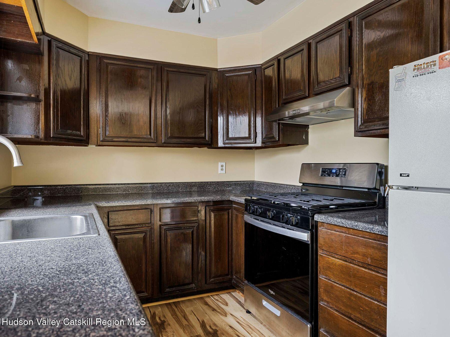 317 Mitchell Hollow Road Windham, NY 12496 - Photo 18 of 41 a kitchen with granite countertop a stove and a sink