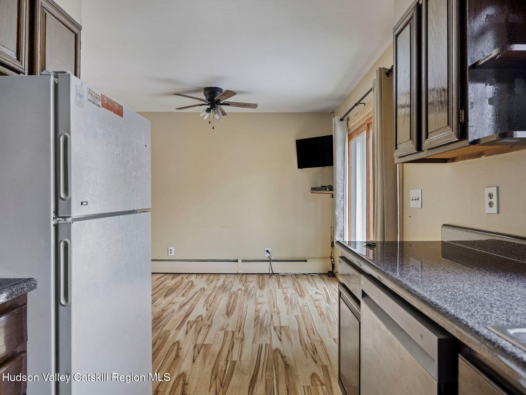 317 Mitchell Hollow Road Windham, NY 12496 - Photo 19 of 41 a view of a kitchen with wooden floor and a ceiling fan