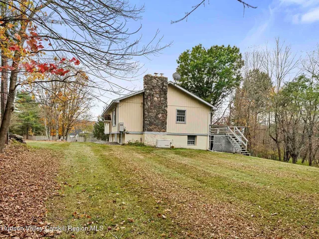 a living room with a fireplace and a wooden floor