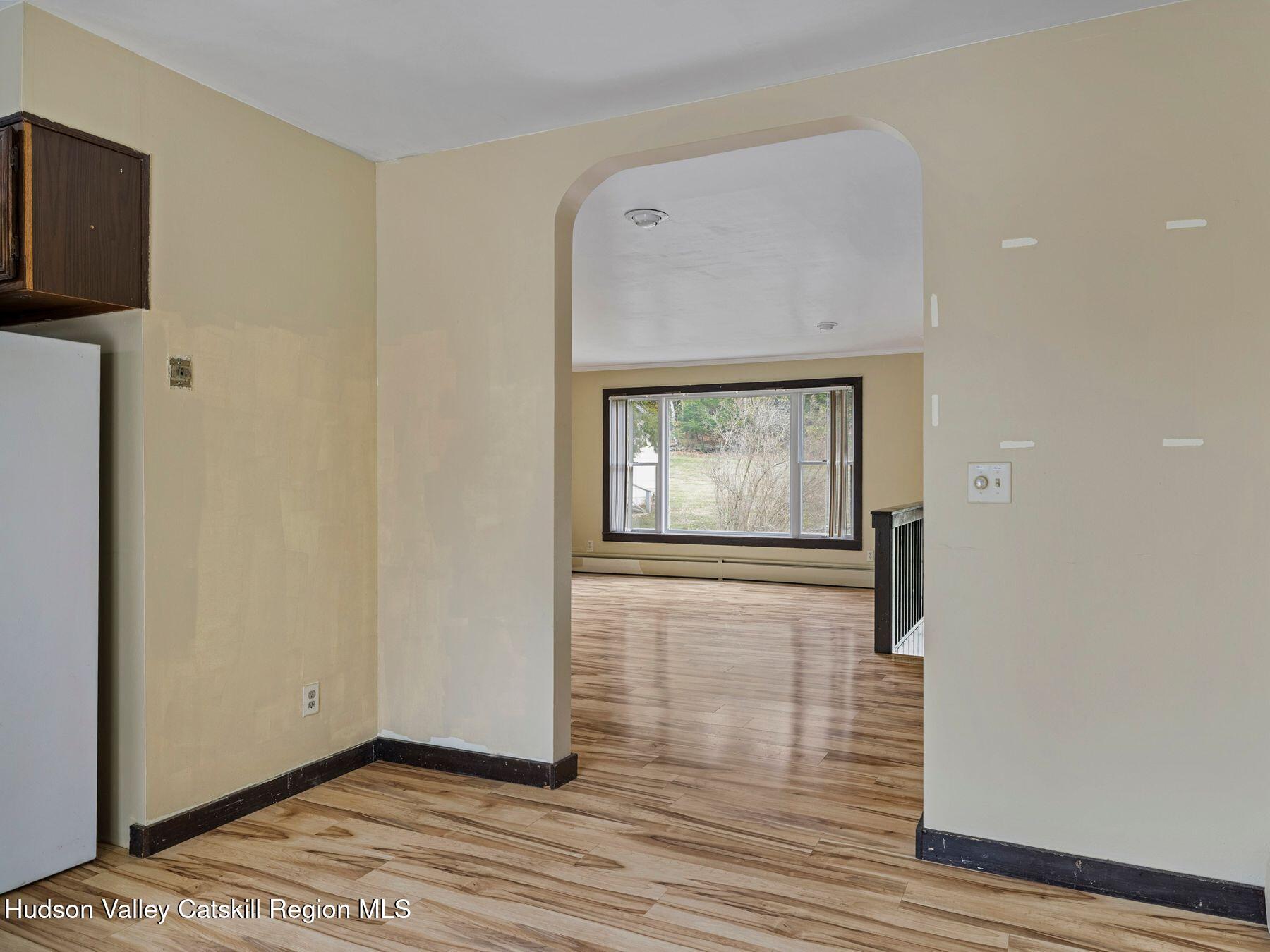 317 Mitchell Hollow Road Windham, NY 12496 - Photo 22 of 41 a view of an empty room with wooden floor and a window