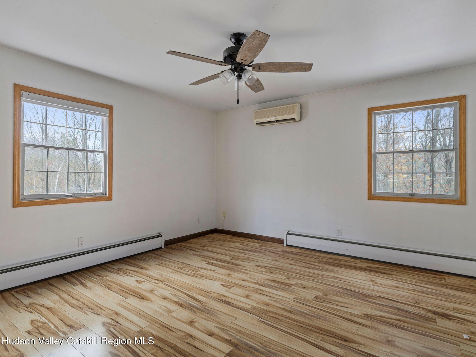 317 Mitchell Hollow Road Windham, NY 12496 - Photo 23 of 41 a view of an empty room with wooden floor and a window
