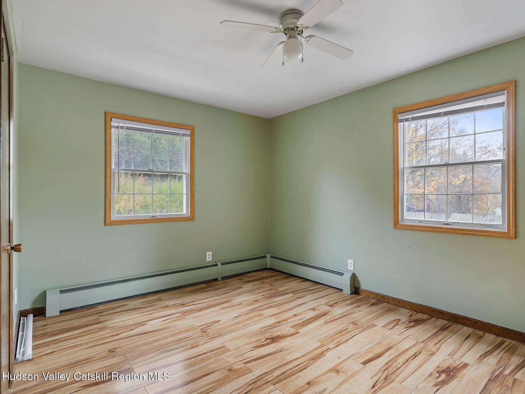 317 Mitchell Hollow Road Windham, NY 12496 - Photo 25 of 41 a view of empty room with wooden floor and fan