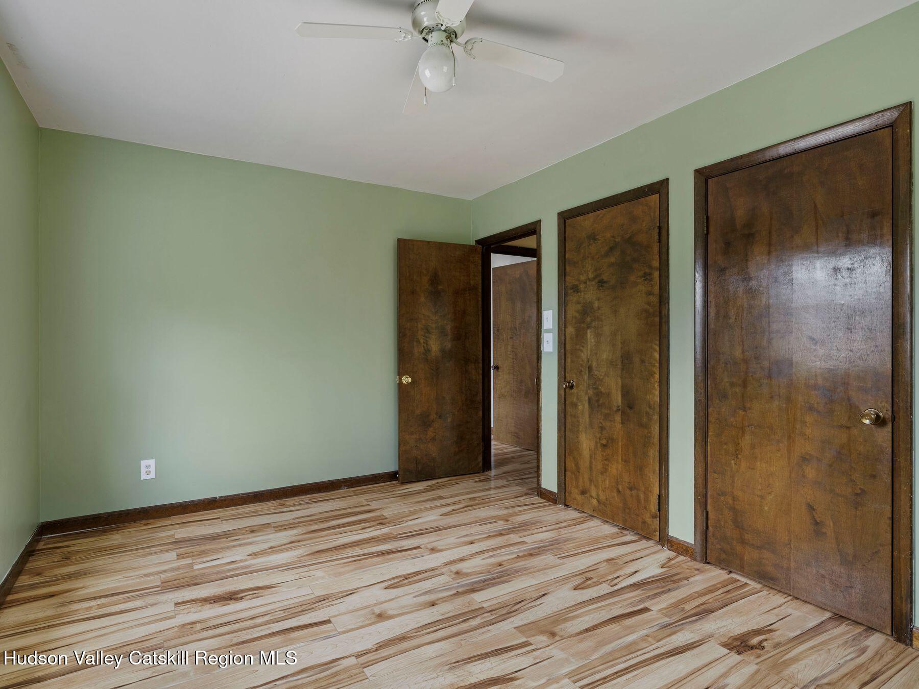 317 Mitchell Hollow Road Windham, NY 12496 - Photo 26 of 41 a view of a room with wooden floor and a ceiling fan