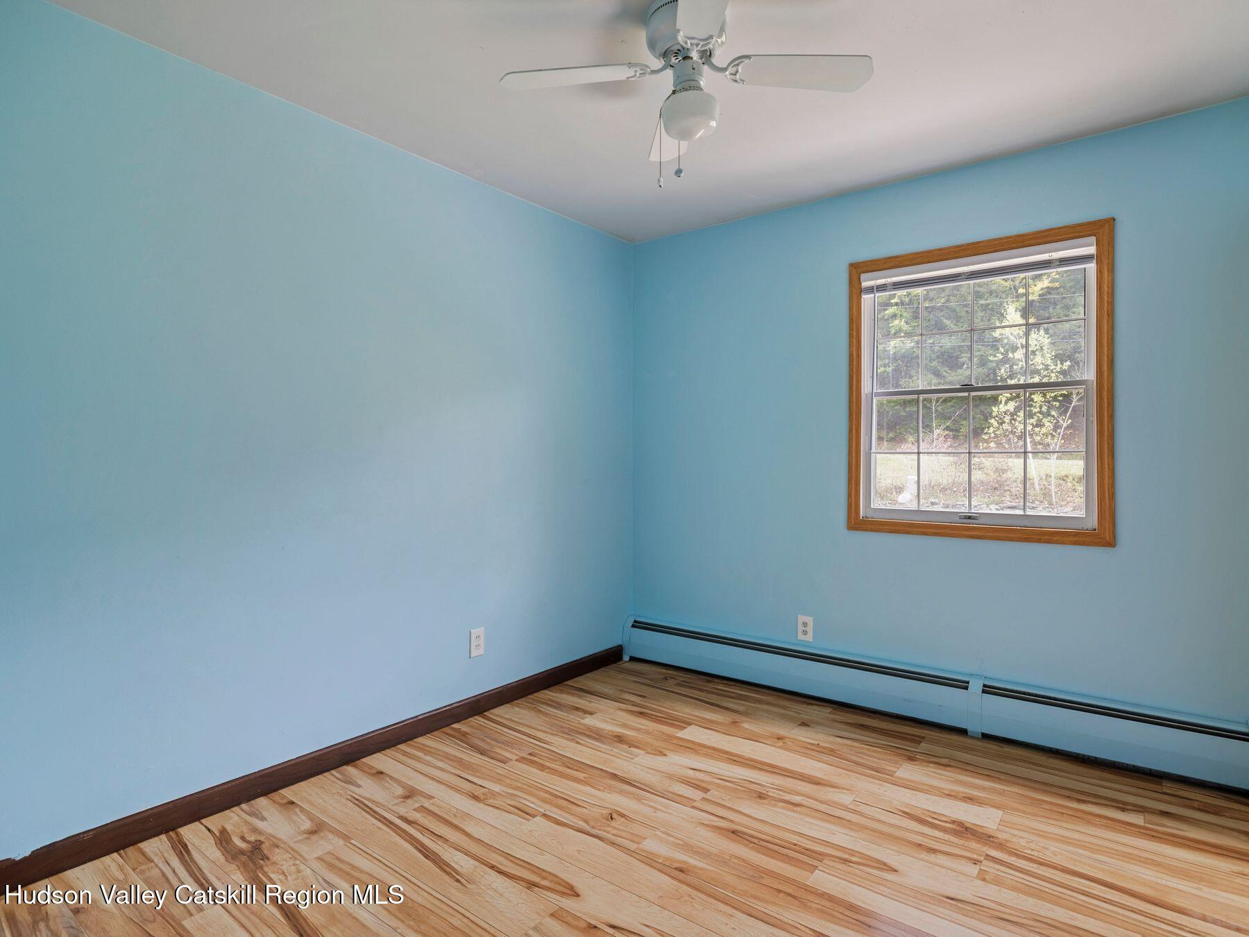 317 Mitchell Hollow Road Windham, NY 12496 - Photo 27 of 41 a view of empty room with wooden floor and fan