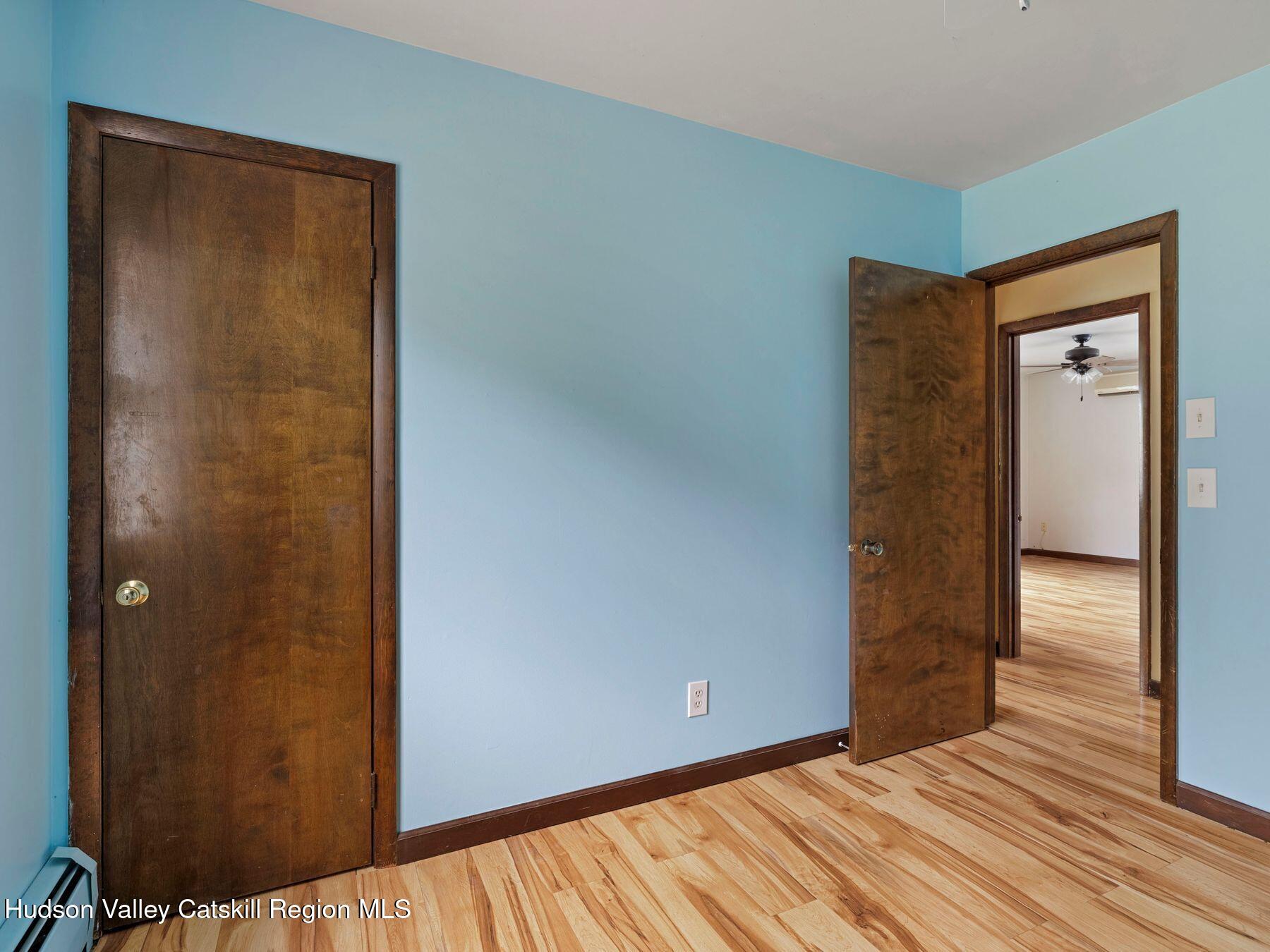 317 Mitchell Hollow Road Windham, NY 12496 - Photo 28 of 41 a view of an empty room with wooden floor and a window