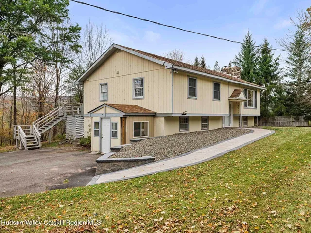 a view of empty room with wooden floor and fireplace