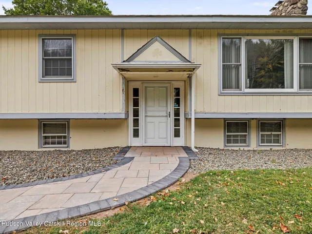 a view of empty room with wooden floor and fireplace