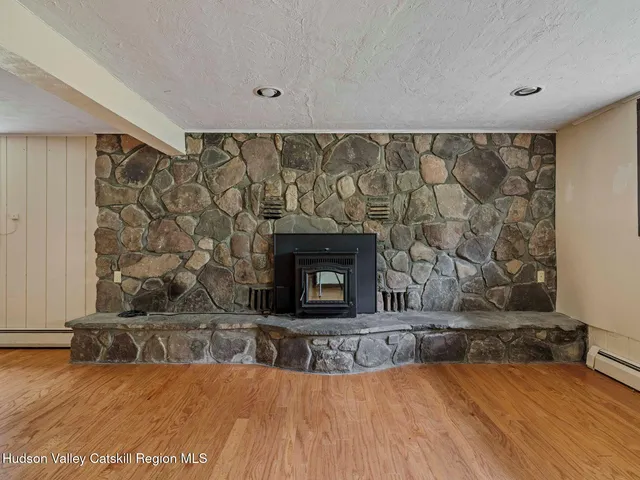 a view of a kitchen with wooden floor and a ceiling fan