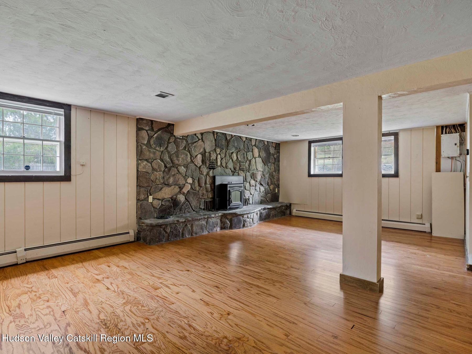 317 Mitchell Hollow Road Windham, NY 12496 - Photo 6 of 41 a view of a livingroom with wooden floor and a fireplace
